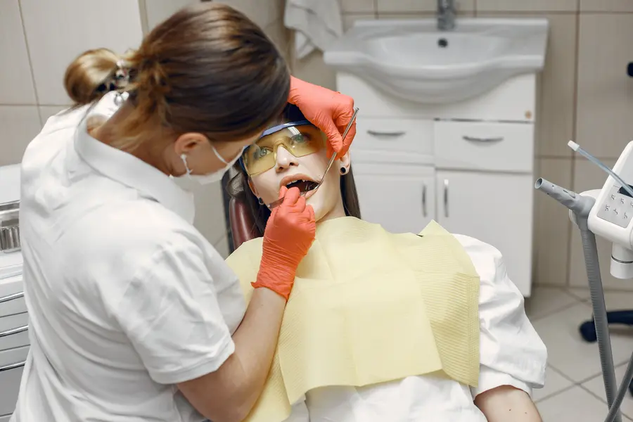 nitrous-oxide-sedation-montgomery-county-dentist-examining-patient-teeth-with-mirror